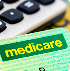 Green Medicare card in front of calculator